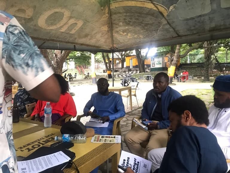 Collaborative meeting with diverse group of Nigerians